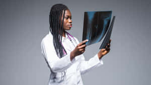 Radiant Young Black Woman With X-rays In A Medical Setting Wallpaper