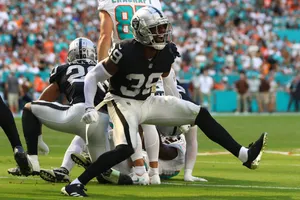 Raiders Defensive Actionat Football Game Wallpaper