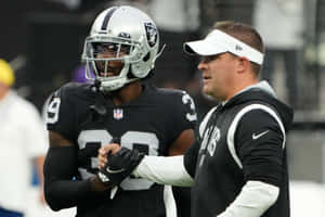 Raiders Playerand Coach Discussion Wallpaper