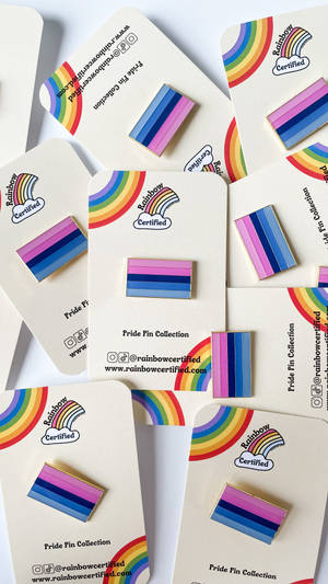 Rainbow Pins With A Rainbow Colored Stripe Wallpaper