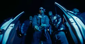 Rap Group Exiting S U V Nighttime Wallpaper