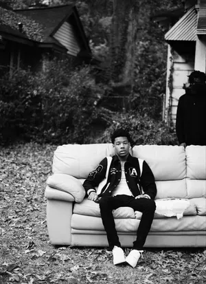 Rapper Nardo Wick On Outdoor Couch Wallpaper