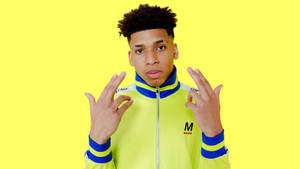 Rapper Nle Choppa Stands Ready With A Microphone. Wallpaper