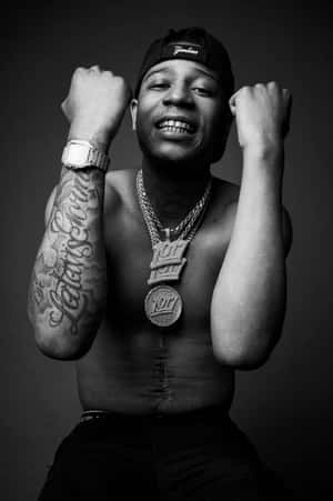 Rapper Showing Off Tattoosand Jewelry Wallpaper