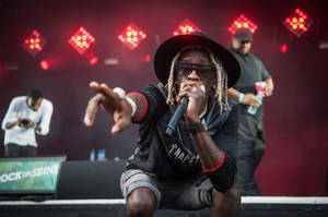 Rapper Young Thug Brings The Audience To Their Feet During A Live Performance Wallpaper