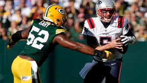 Rashan Gary Pursuing Opponent Quarterback Wallpaper