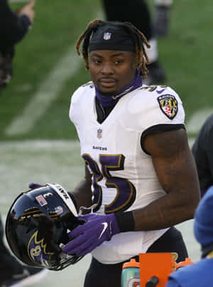 Ravens Player Gus Edwards Holding Helmet Wallpaper