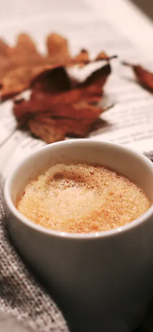 Red And Yellow Leaves Amidst A Scene Of Mountain Peaks Wallpaper