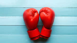 Red Boxing Gloveson Blue Background Wallpaper