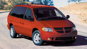 Red Dodge Grand Caravan On Road Wallpaper