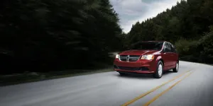 Red Dodge Grand Caravan On The Road.jpg Wallpaper