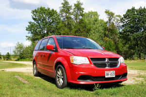 Red Dodge Grand Caravan Parked Outdoors Wallpaper