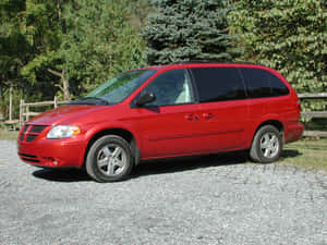 Red Dodge Grand Caravan Parked Outdoors Wallpaper