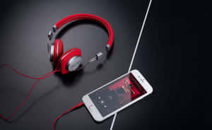 Red Headphoneswith Smartphone Music Setup Wallpaper