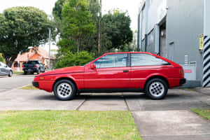 Red Isuzu Impulse Parkedon Street Wallpaper