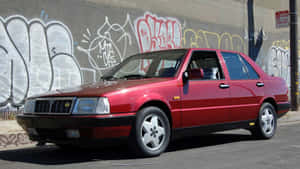 Red Lancia Thema Urban Backdrop Wallpaper