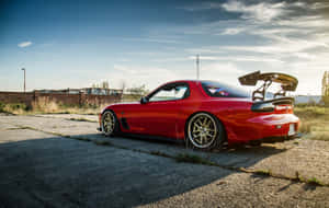 Red Mazda Rx 7 Under Blue Sky Wallpaper