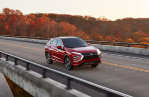 Red Mitsubishi Eclipse Cross On Highway During Autumn Wallpaper