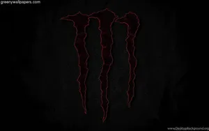 Red Monster Logo Illuminated On Dark Screen Wallpaper