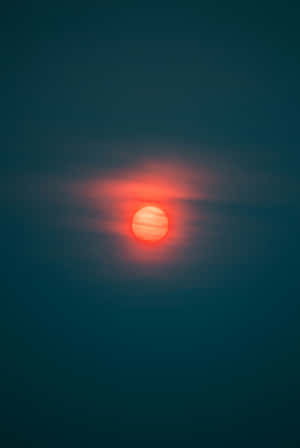 Red Moon Glowing Through Haze Wallpaper