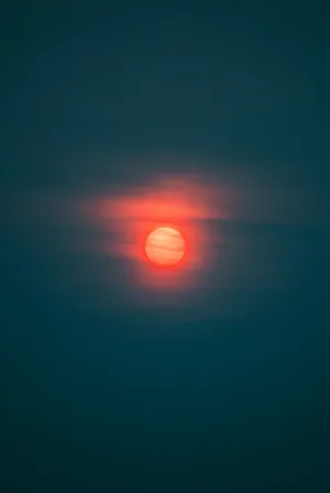 Red Moon Glowing Through Haze Wallpaper