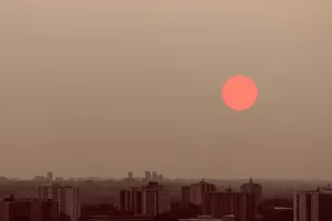 Red Moon Over Cityscape Wallpaper
