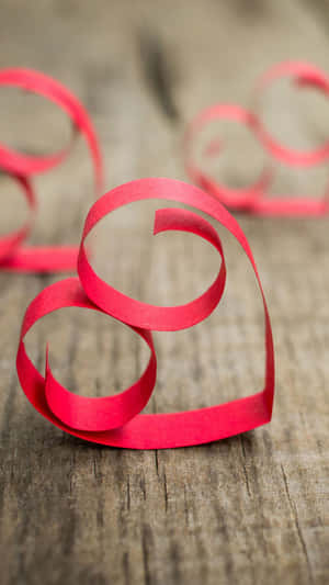 Red Paper Heart Shaped On A Wooden Table Wallpaper