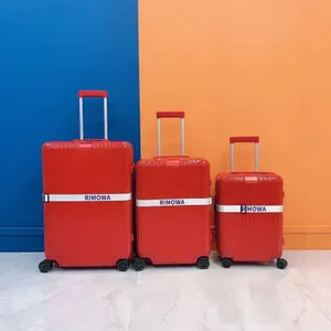 Red Rimowa Suitcases Blue Orange Background Wallpaper