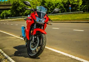 Red Sport Motorcycle Parked Roadside Wallpaper