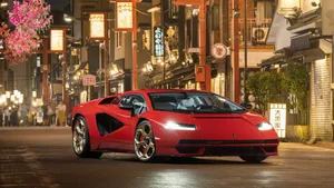 Red Sports Car Nighttime Cityscape Wallpaper