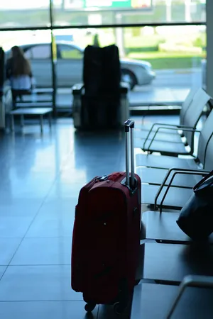 Red Suitcase Waiting Area Airport Wallpaper