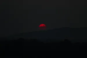 Red Sun On Black Tablet Wallpaper