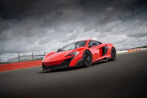 Red Supercar Speedingon Track Wallpaper