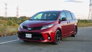 Red Toyota Sienna Minivan Parked Outdoors Wallpaper