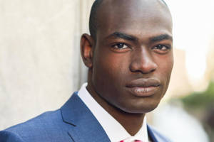 Refined Elegance: A Handsome Black Man In A Pink Blush Wallpaper