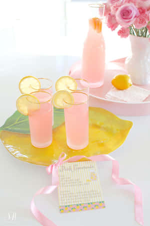 Refreshing Pink Lemonade In Glass Jar With Sliced Lemons Wallpaper