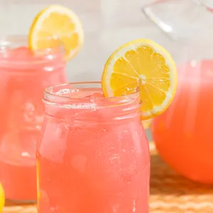 Refreshing Pink Lemonade In Glass With Lemon Slices Wallpaper
