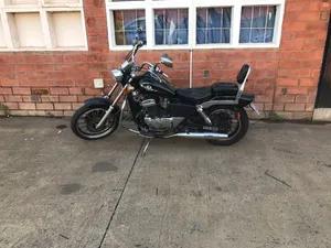 Regal Raptor Motorcycle Parked Outdoors Wallpaper