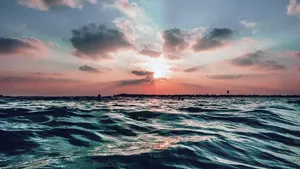 Relax On The Sand And Take In The Views Of A Stunning Beach Scene. Wallpaper