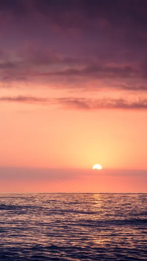 Relaxation And Tranquillity Of The Beach With A Touch Of Sunset Wallpaper