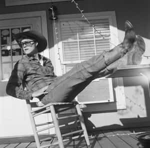 Relaxed Cowboy Leaning Back Wallpaper
