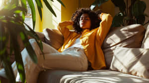 Relaxed Woman Sunlit Couch Wallpaper