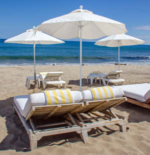 Relaxing Beach Daybed By The Ocean Wallpaper