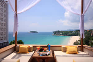 Relaxing Beach Daybed Overlooking The Ocean Wallpaper