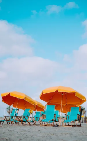 Relaxing Beach Scene With Colorful Umbrella Wallpaper