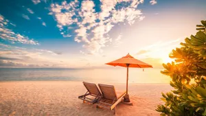 Relaxing Beach Sunbed On A Sunny Coastline Wallpaper