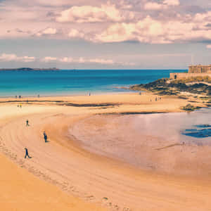 Relaxing Beach Walk At Sunset Wallpaper