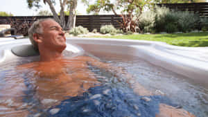 Relaxing Manin Outdoor Hot Tub Wallpaper