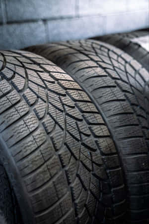 Reliable Winter Tires On Snowy Road Wallpaper