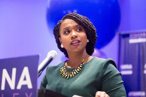 Representative Ayanna Pressley Against A Striking Violet Background Wallpaper